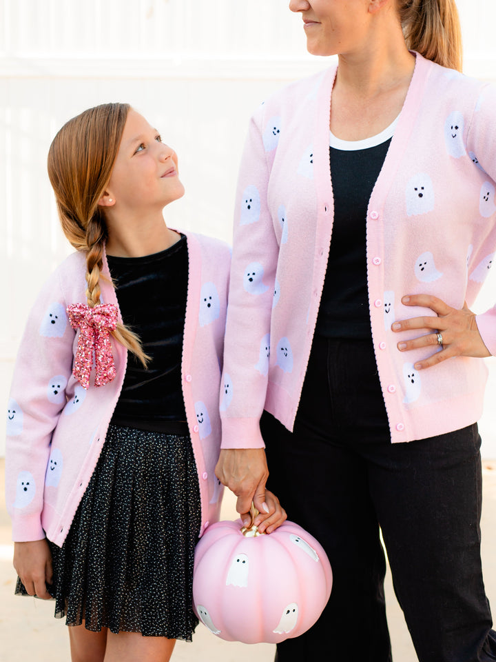 little girl and mama holding pink pumpkin wearing matching pink V-neck cardigans with buttons and white ghost design for Halloween 