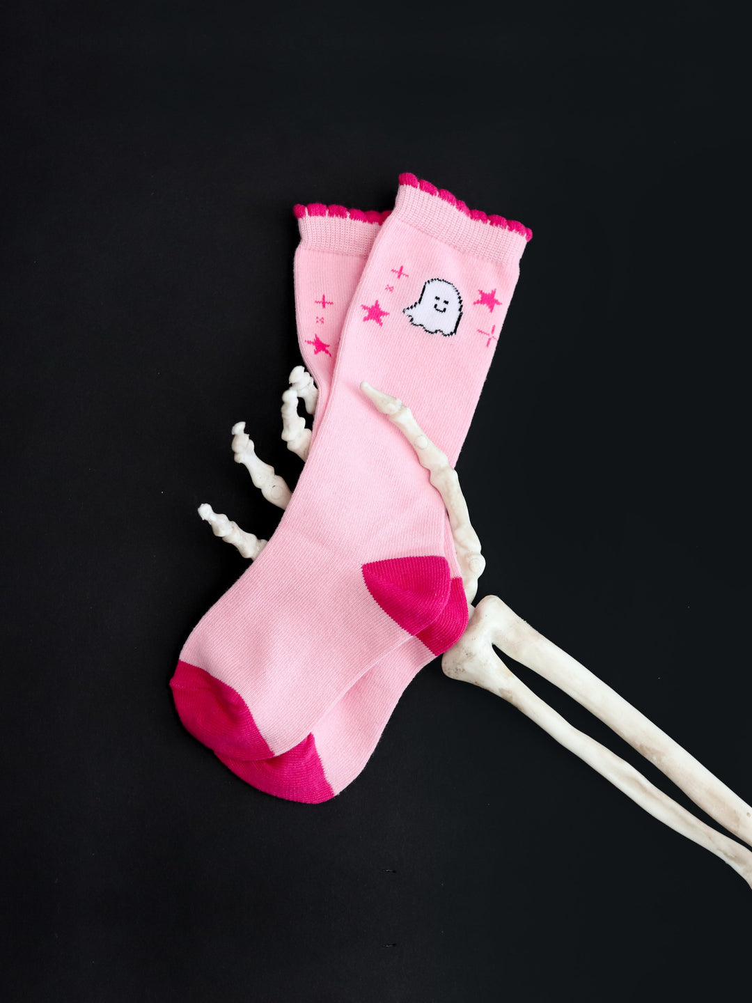 skelly hand holding girls' two tone pink scalloped knee high socks with white ghost design and little pink stars