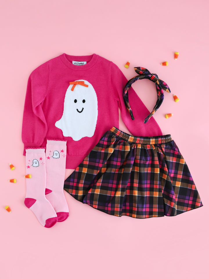 girls' bright pink sweater with bow wearing ghost design paired with Halloween plaid skort, matching headband and pink ghost knee highs