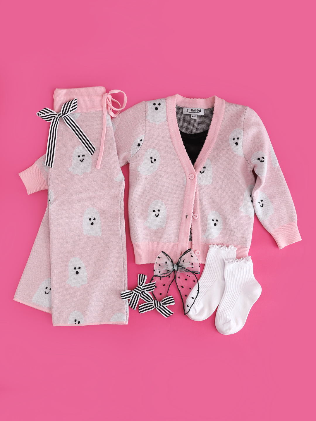 girls' light pink button front cardigan and matching sweater pants with ghost print paired with matching Halloween accessories