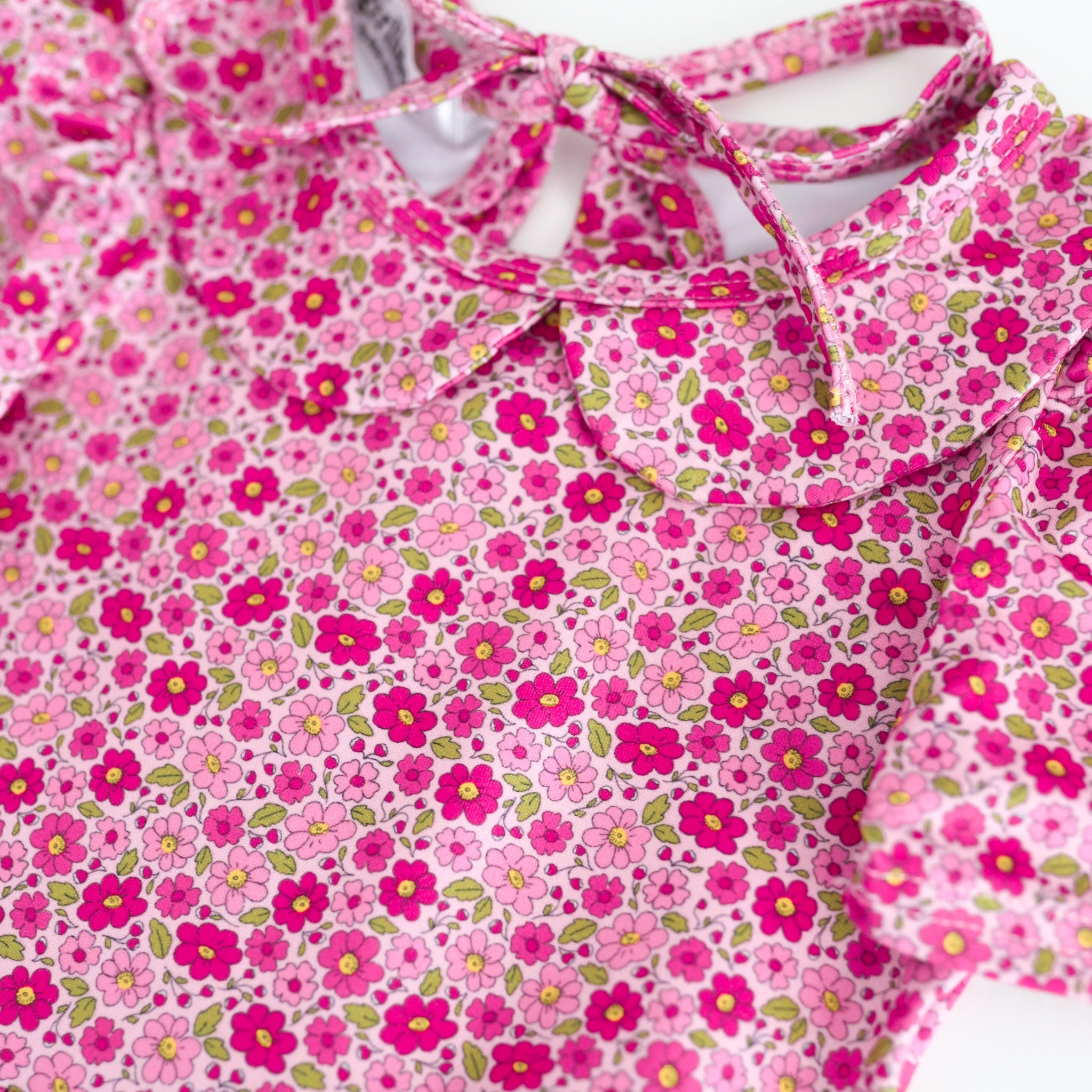 detail photo of petite floral print in shades of pink on dress bodice with peter pan collar