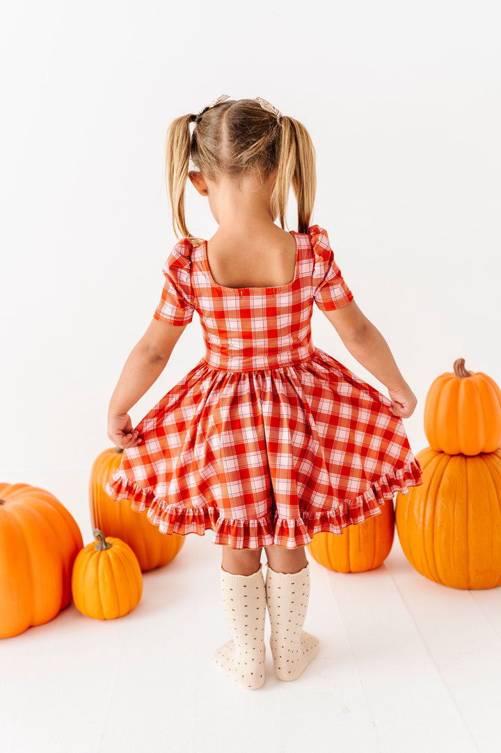 back detail of girls pink and orange plaid dress