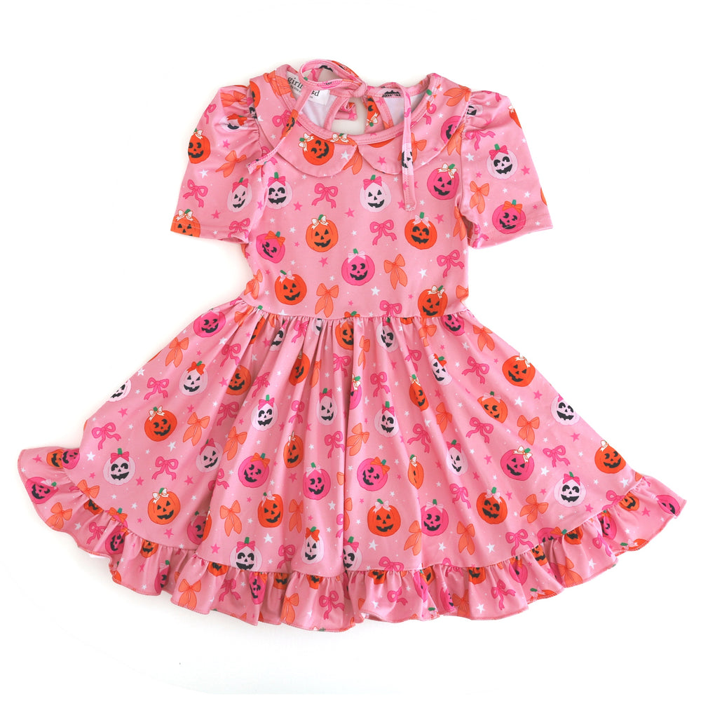 girl's pink collared twirl dress with puff sleeve, ruffle hem and darling pumpkin and bow print for Halloween