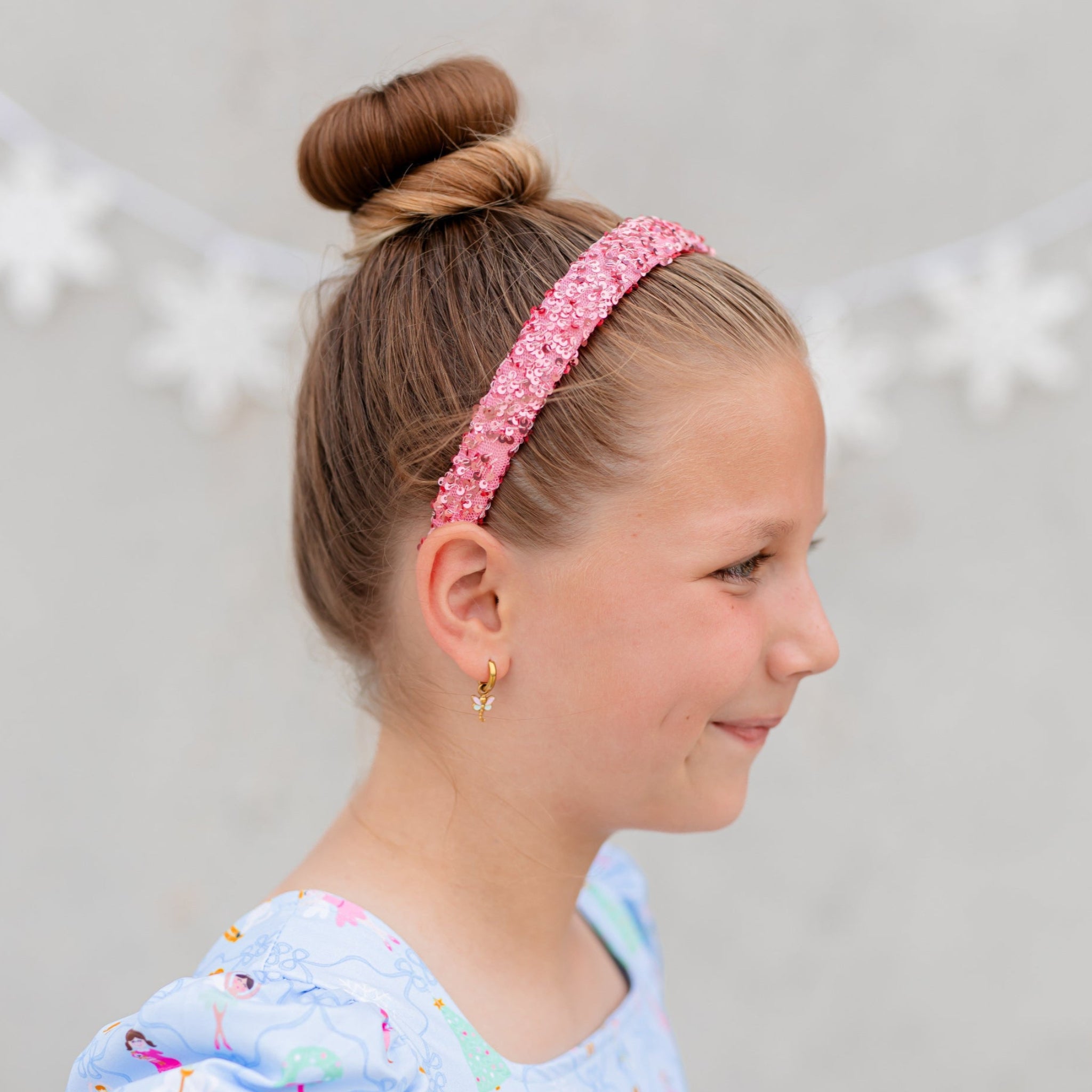 little girl in pink sequin headband to match winter wonderland nutcracker inspired twirl dress 