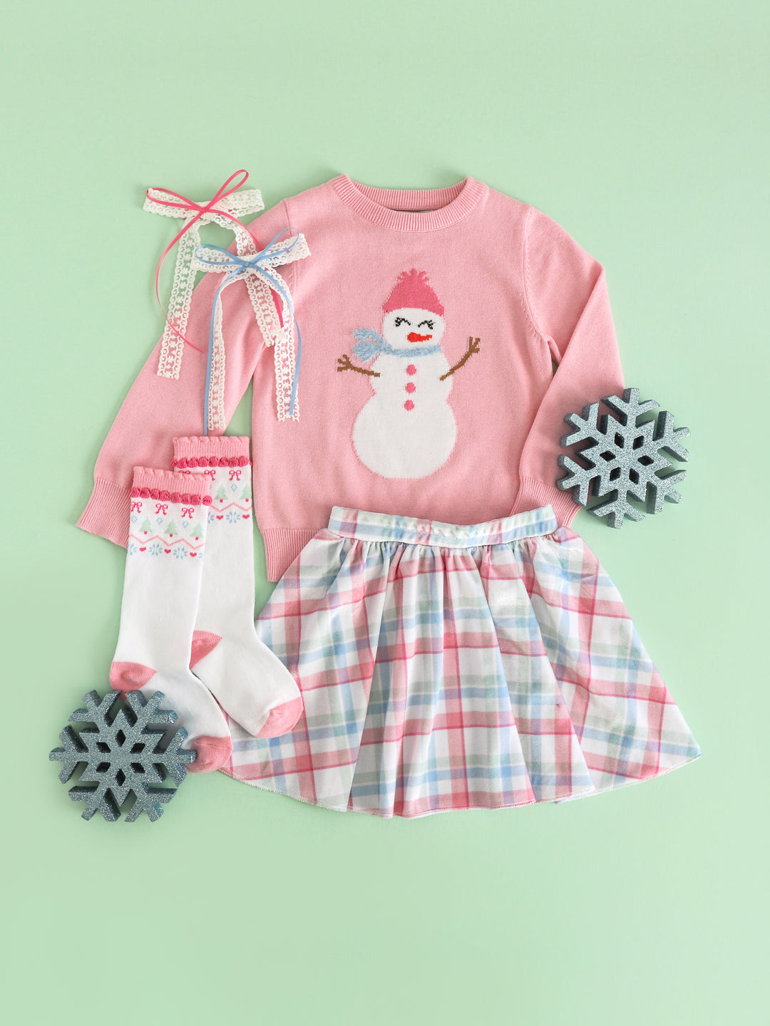 girls' pink pullover knit sweater with snowgirl design paired with pastel velvet plaid skirt, matching fair isle knee highs and hair bows for winter wonderland vibes