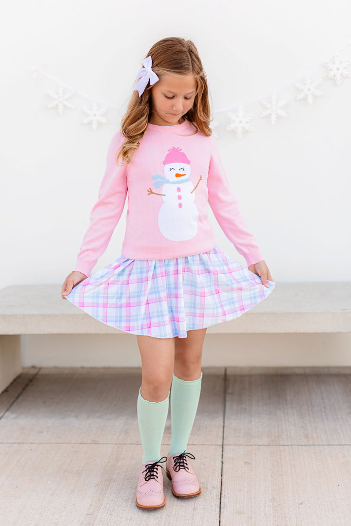 young girl in pastel winter wonderland themed snowgirl outfit with matching sweater, velvet skirt, knee highs and velvet hair bow