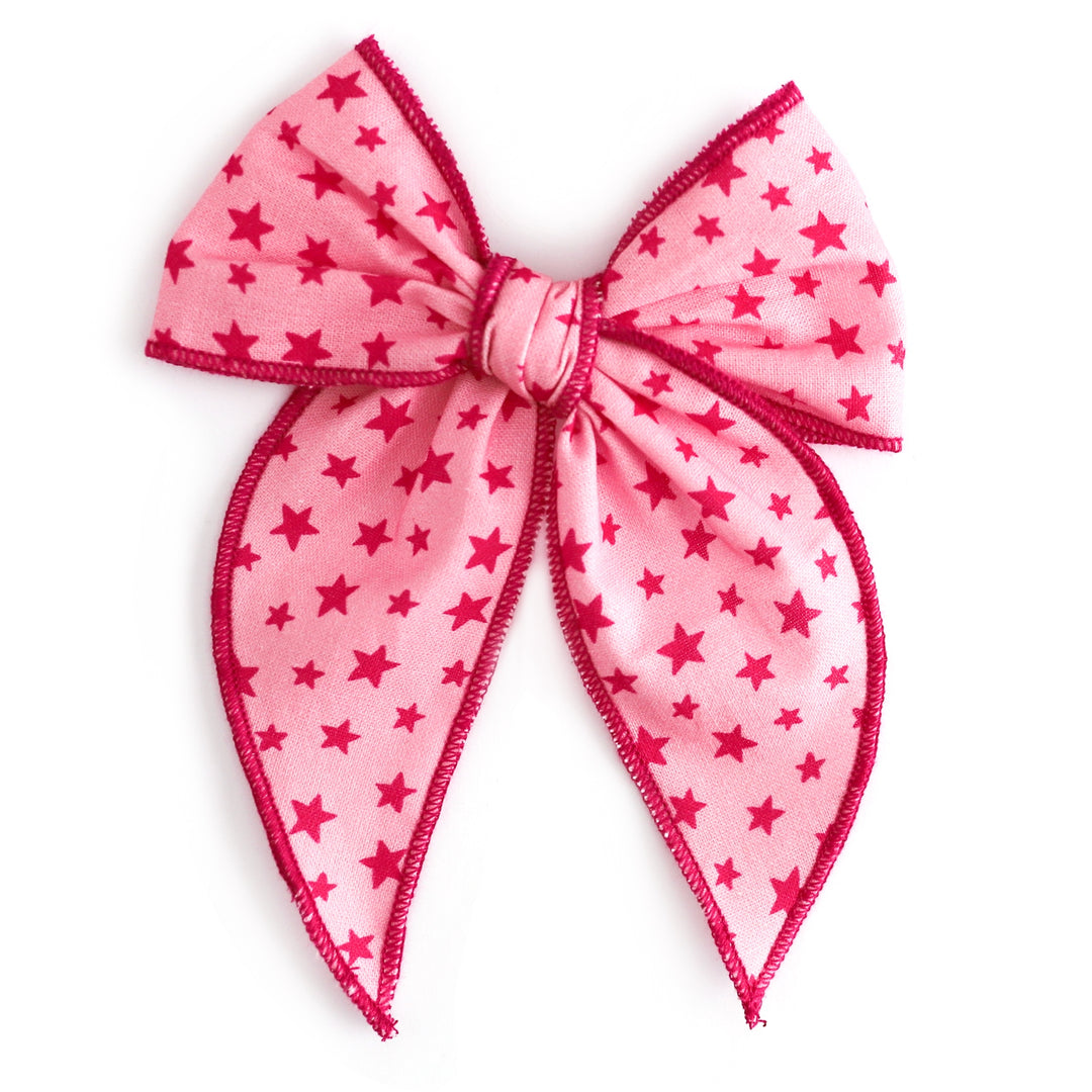 girls' hand tied pink ow with dark pink mini stars print and pink trim on alligator clip