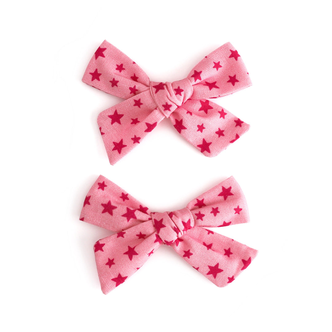 little girl's pink pigtail bows on clips with pink star print