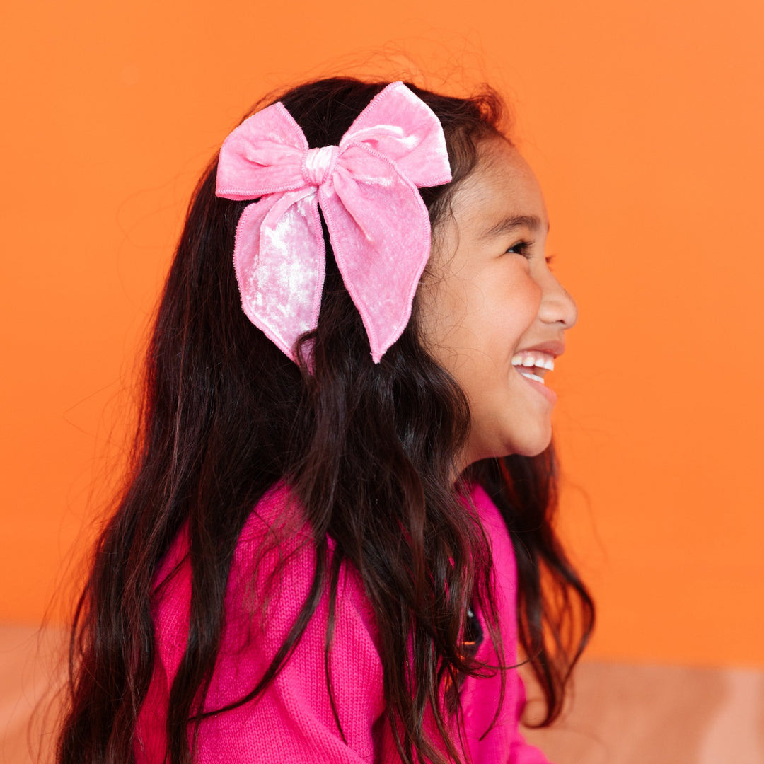 girls light pink velvet hairbow paired with hot pink cardigan