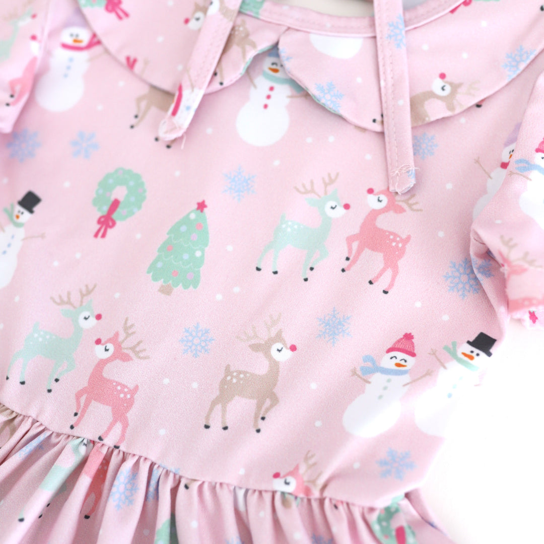 closeup of light pink collared twirl dress bodice with pastel reindeer, Christmas trees, snowmen and snowflake print