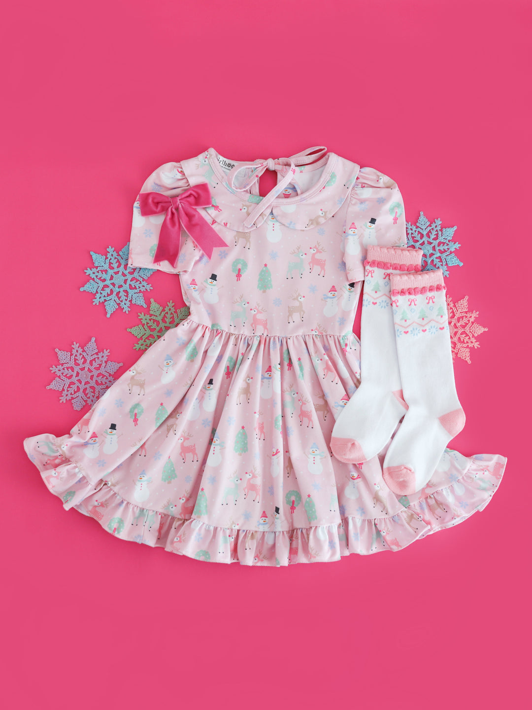 girls pastel pink collared twirl dress with winter themed print, matching white knee highs with pastel fair isle print and pink velvet ribbon hair bow