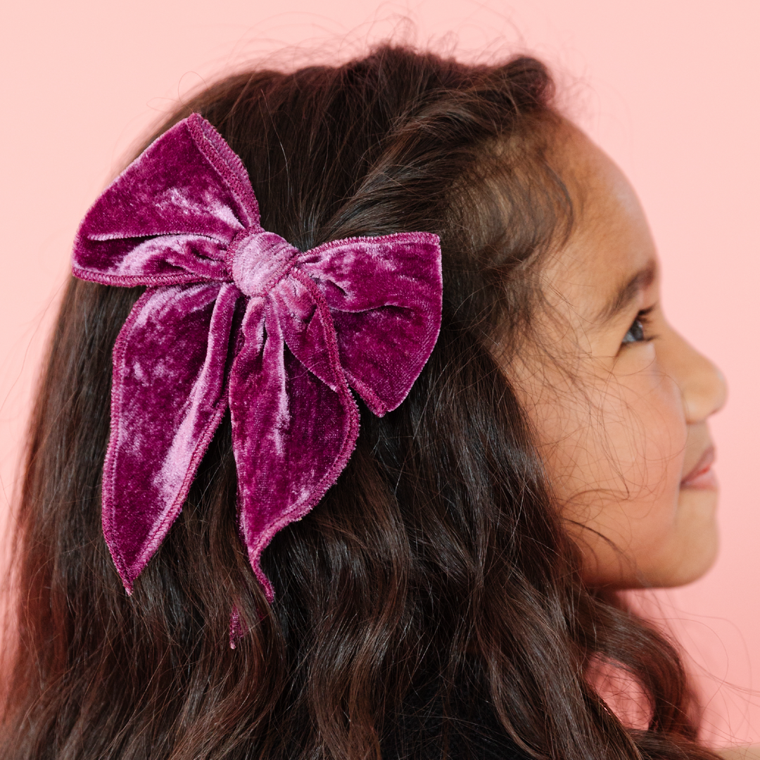 girl wearing plum purple velvet hair bow