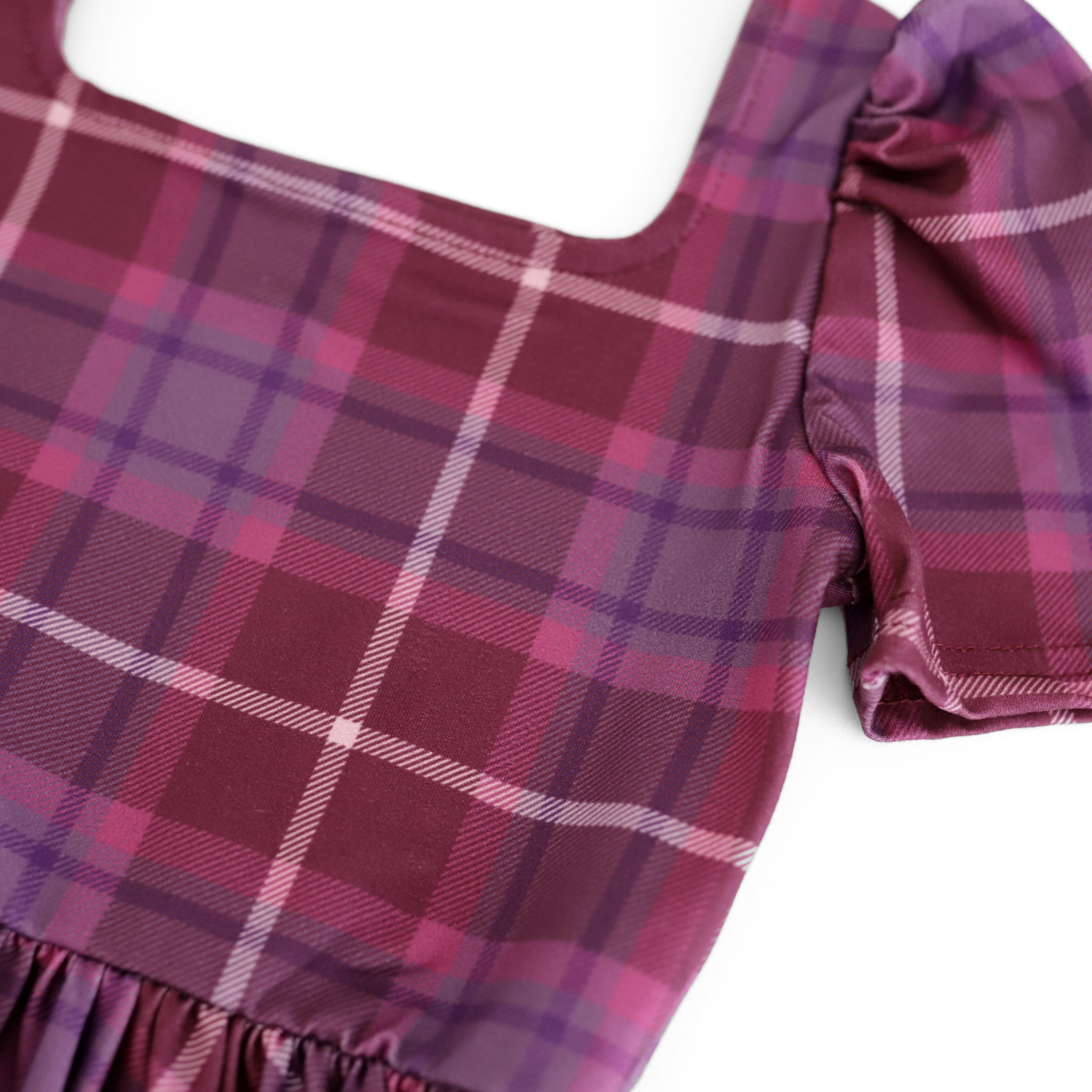 close-up of purple plaid twirl dress print for little girl's fall wardrobe