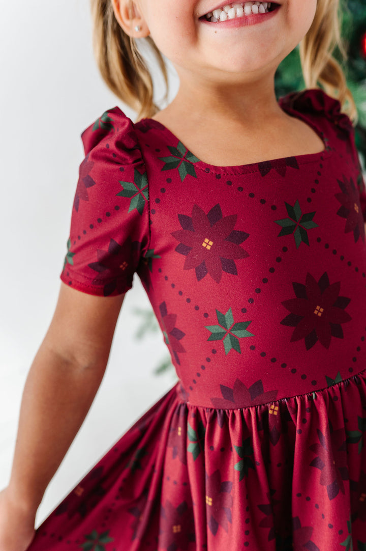 up-close detail of poinsettia print girls christmas dress