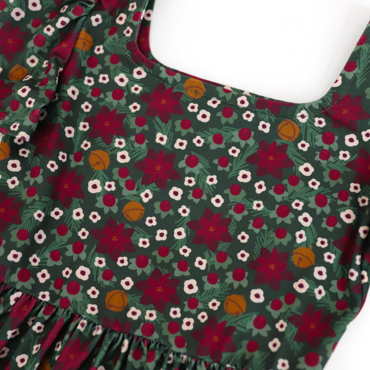 closeup of little girls Christmas dress with forest green, crimson and gold color scheme and square neckline