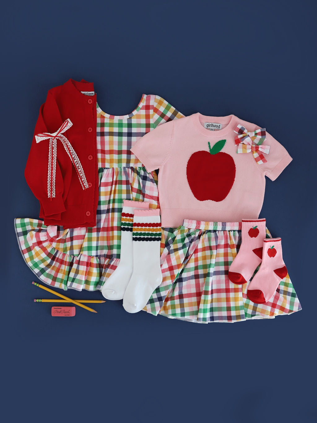 girls' primary gingham print twirl dress and skort paired with matching pink apple sweater and red cardigan and accessories for back to school