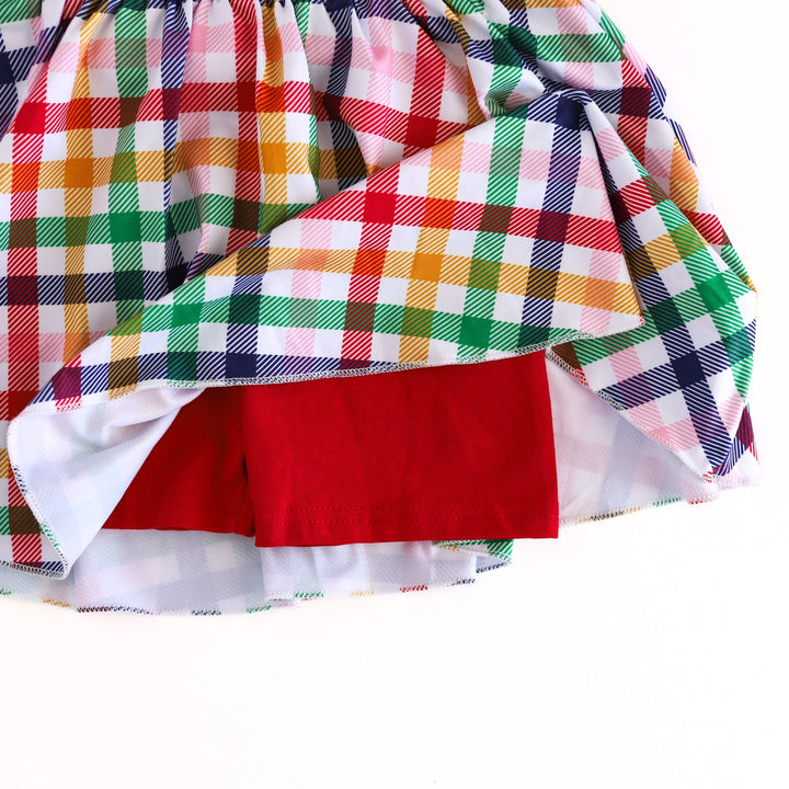 closeup of built-in bright red stretchy shorts attached to primary gingham skort