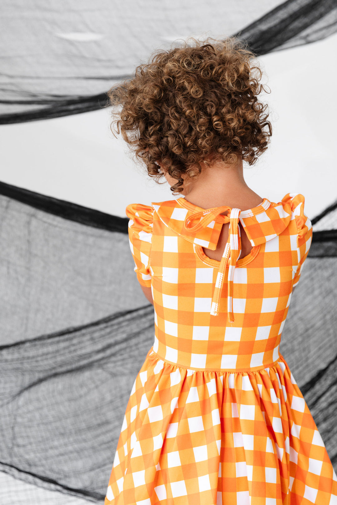 girls orange gingham dress with bow tie back