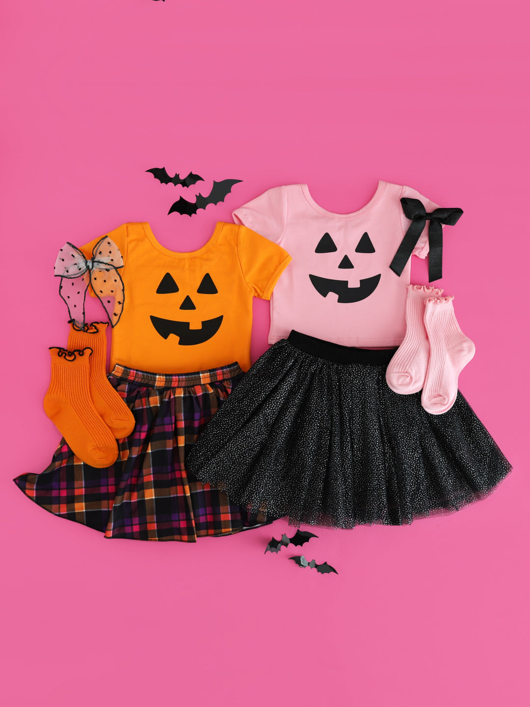 girls t-shirts in orange and pink with jack-o-lantern faces paired with coordinating skorts, midi socks and bows for Halloween 