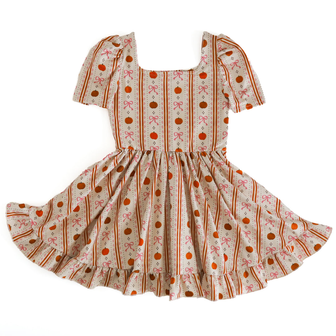 girls square neck twirl dress in cream with wallpaper inspired pumpkin print for fall and Thanksgiving