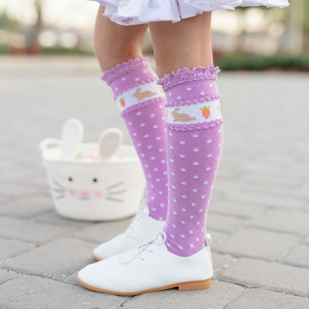 girl in purple knee highs with easter bunnies and carrots