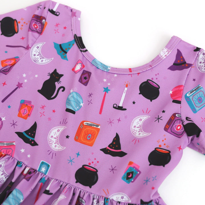 girls' purple halloween dress, witch print detail