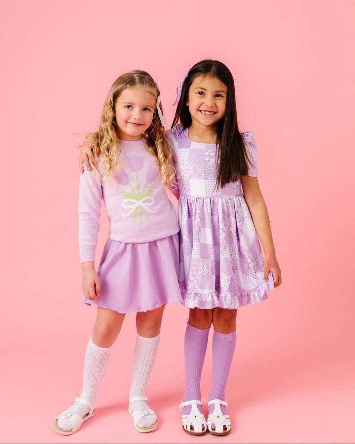 young girls in coordinating lavender and lilac outfits for spring