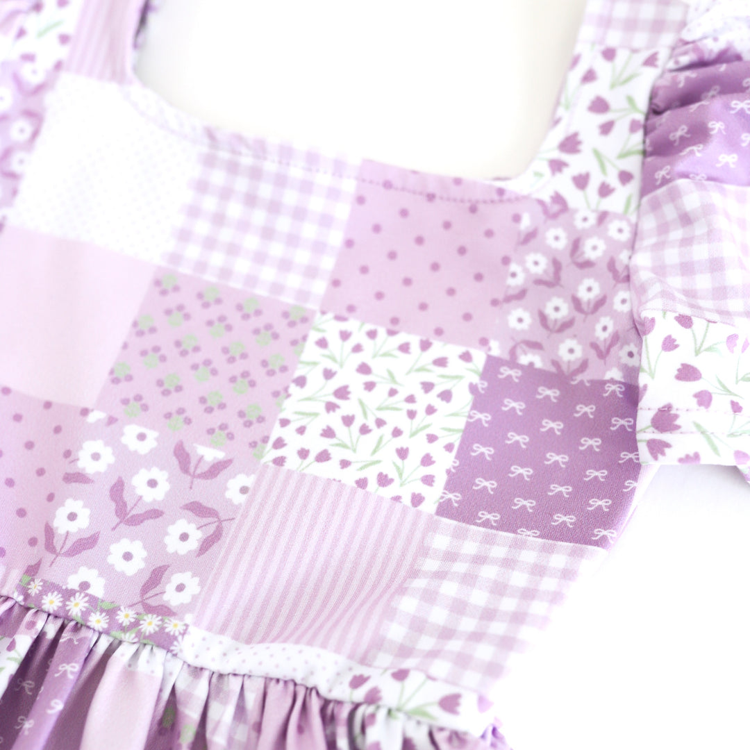 closeup of floral patchwork print on square neck twirl dress in shades of purple for spring
