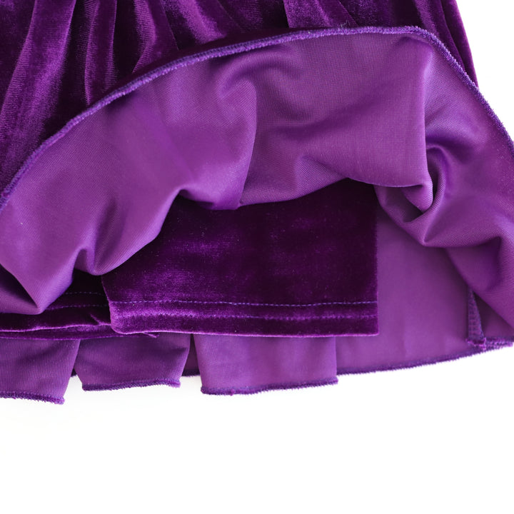 closeup of deep purple velvet shorts attached to Girlhood Skort