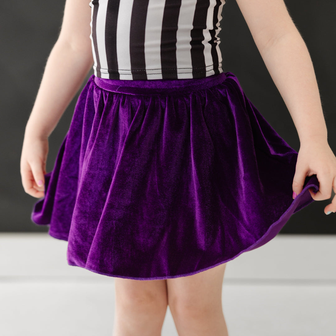 closeup of deep purple velvet skort paired with Beetlejuice inspire striped top for Halloween 
