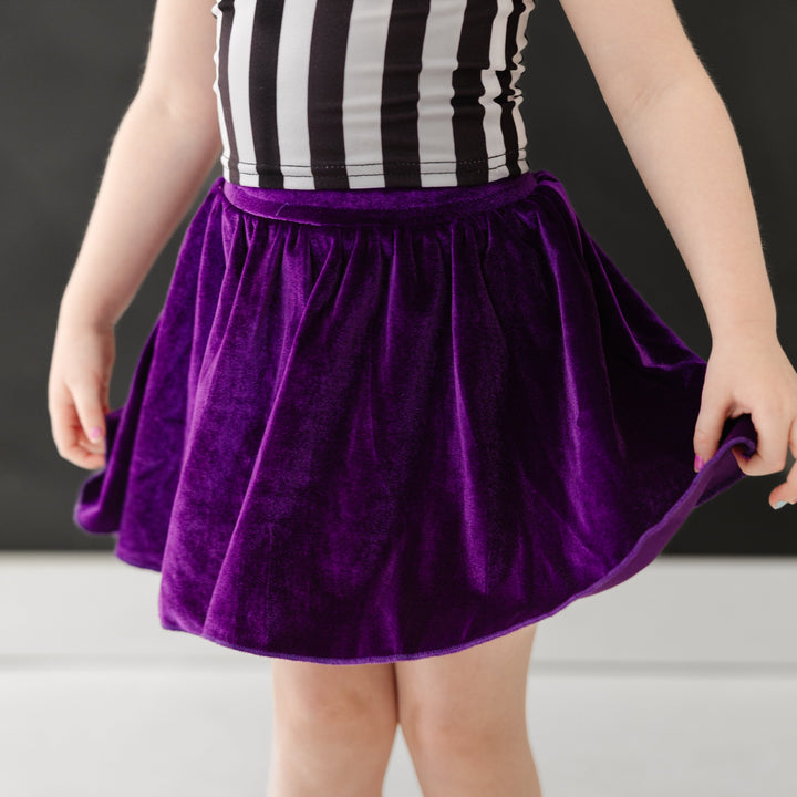 closeup of deep purple velvet skort paired with Beetlejuice inspire striped top for Halloween 