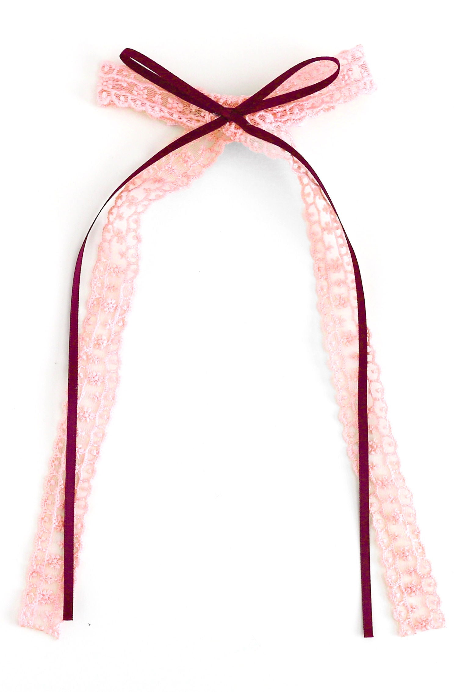 ribbon and lace hair bow with light pink lace and crimson ribbon shown on white background