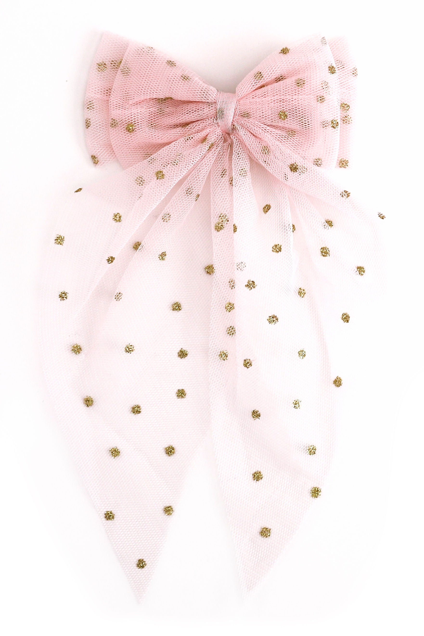 A light pink tulle bow with small gold polka dots, photographed against a plain white background.