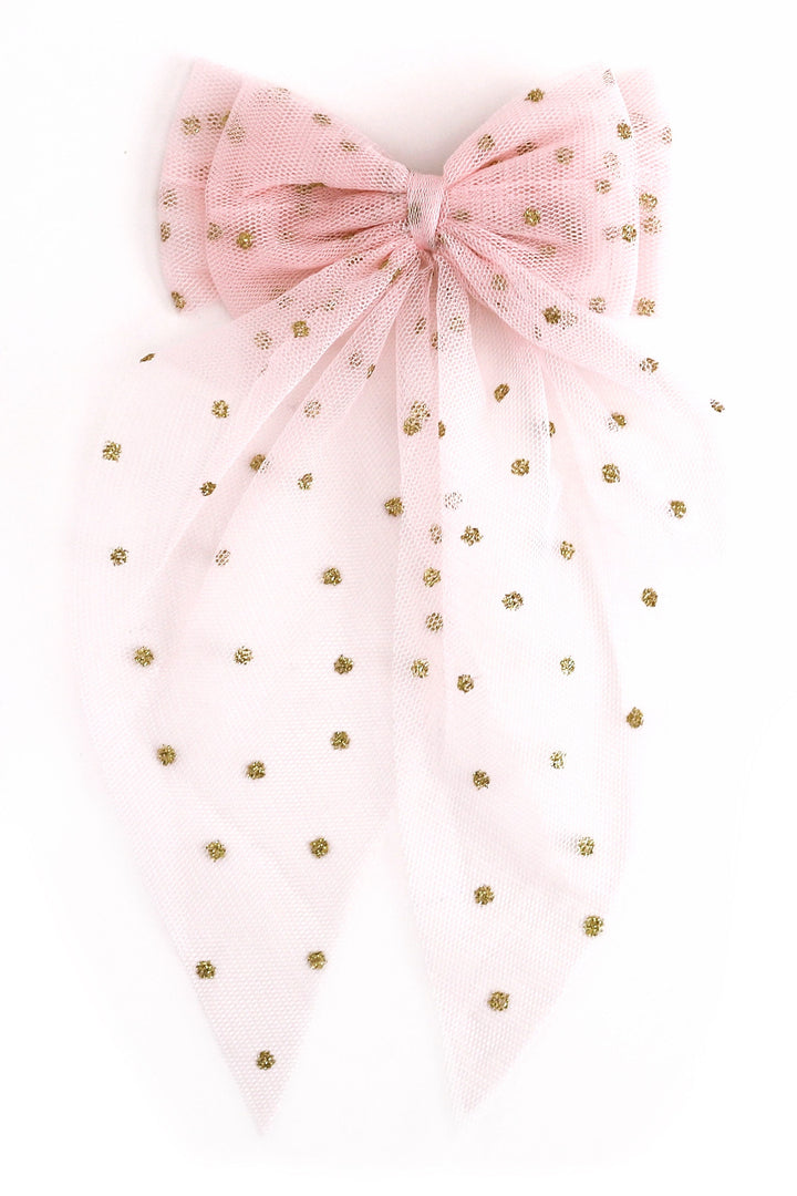 A light pink tulle bow with small gold polka dots, photographed against a plain white background.