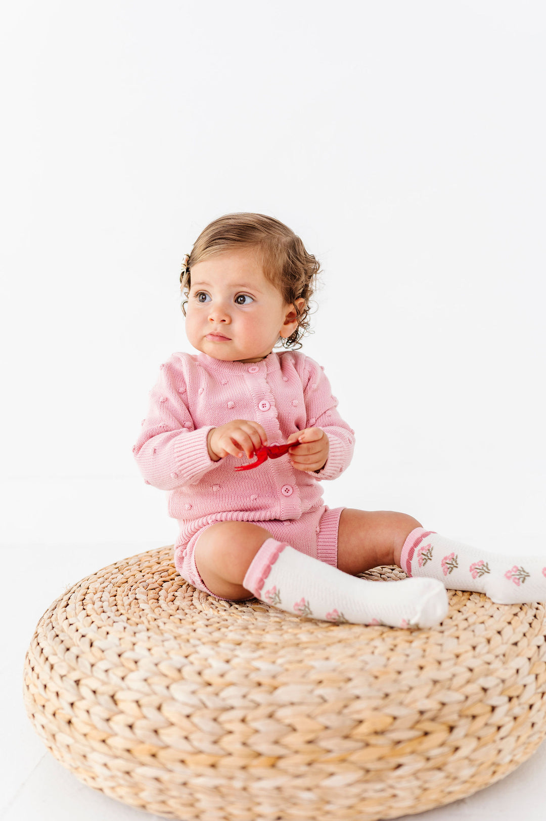 baby girl wearing matching knit set in pink bubble knit