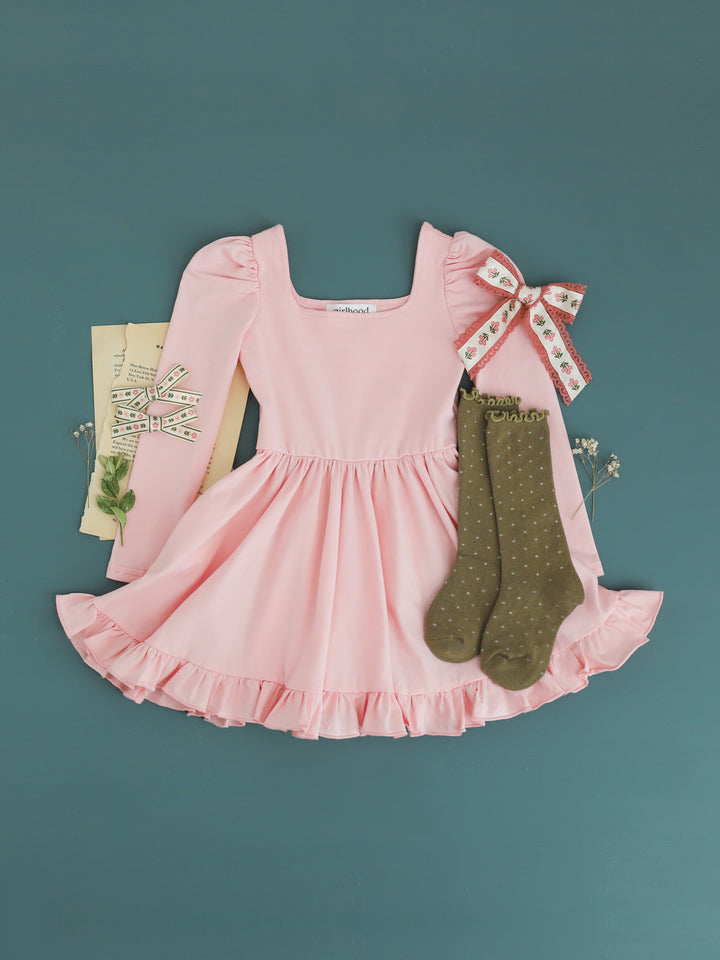 girls' light pink long sleeve twirl dress paired with olive dotted knee socks and coordinating floral hair bows