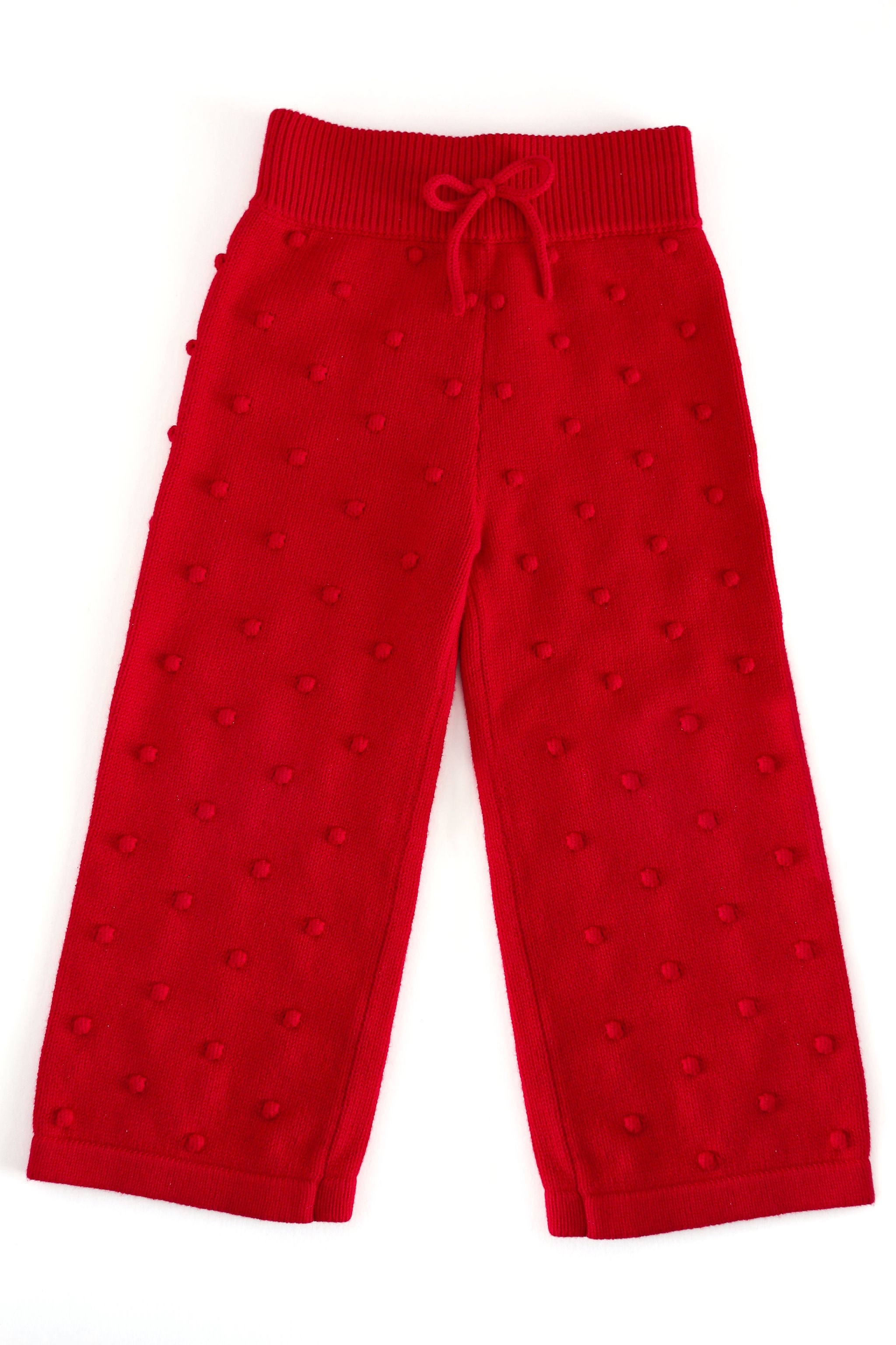 girls' red knit sweater pants with bubble/pom-pom design knit in fabric with a ribbed waistband and faux bow 