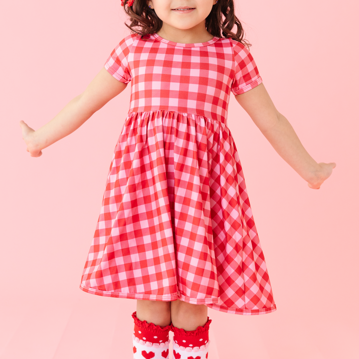 girl wearing red and pink valentine's gingham scoop neck twirl dress