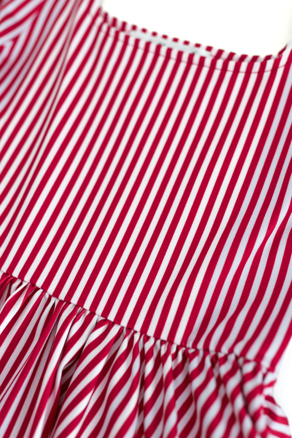 red and white pinstripe dress detail image on white background
