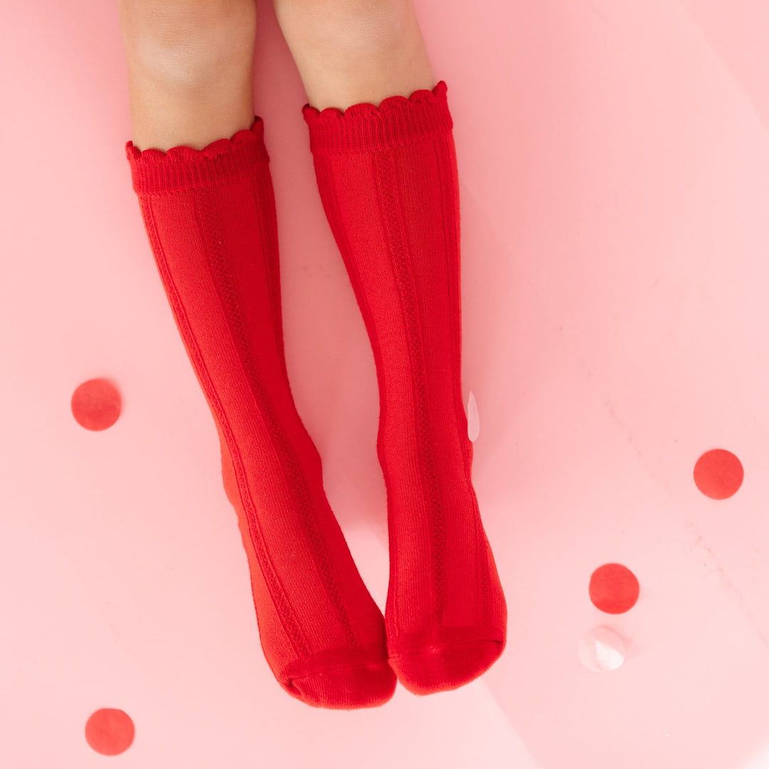 little girl in red scallop trimmed knee highs with vertical knit detail