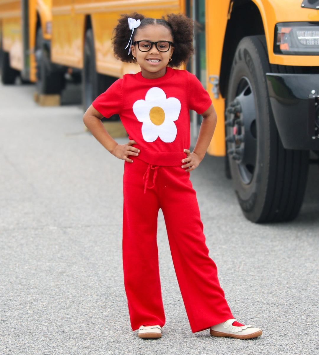 girls in bright red, 100% cotton sweater pants and matching red sweater with white flower on it