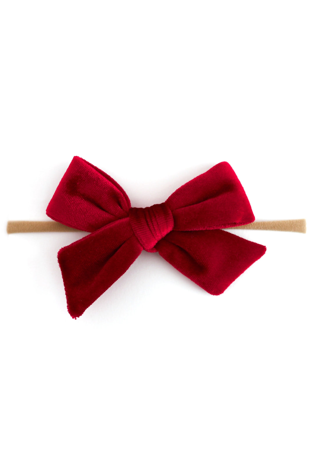 A deep red velvet baby bow on nylon headband on a clean white background.