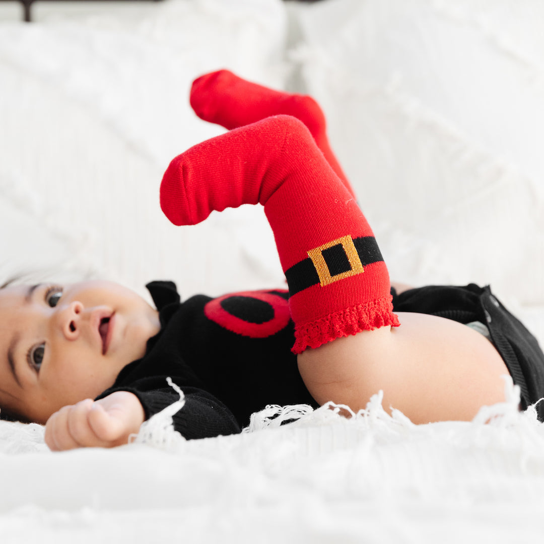 cute baby wearing santa buckle knee high socks with sparkly gold buckle