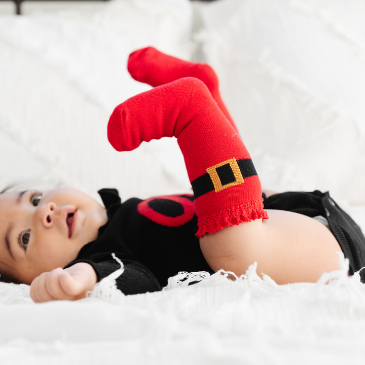 cute baby wearing santa buckle knee high socks with sparkly gold buckle