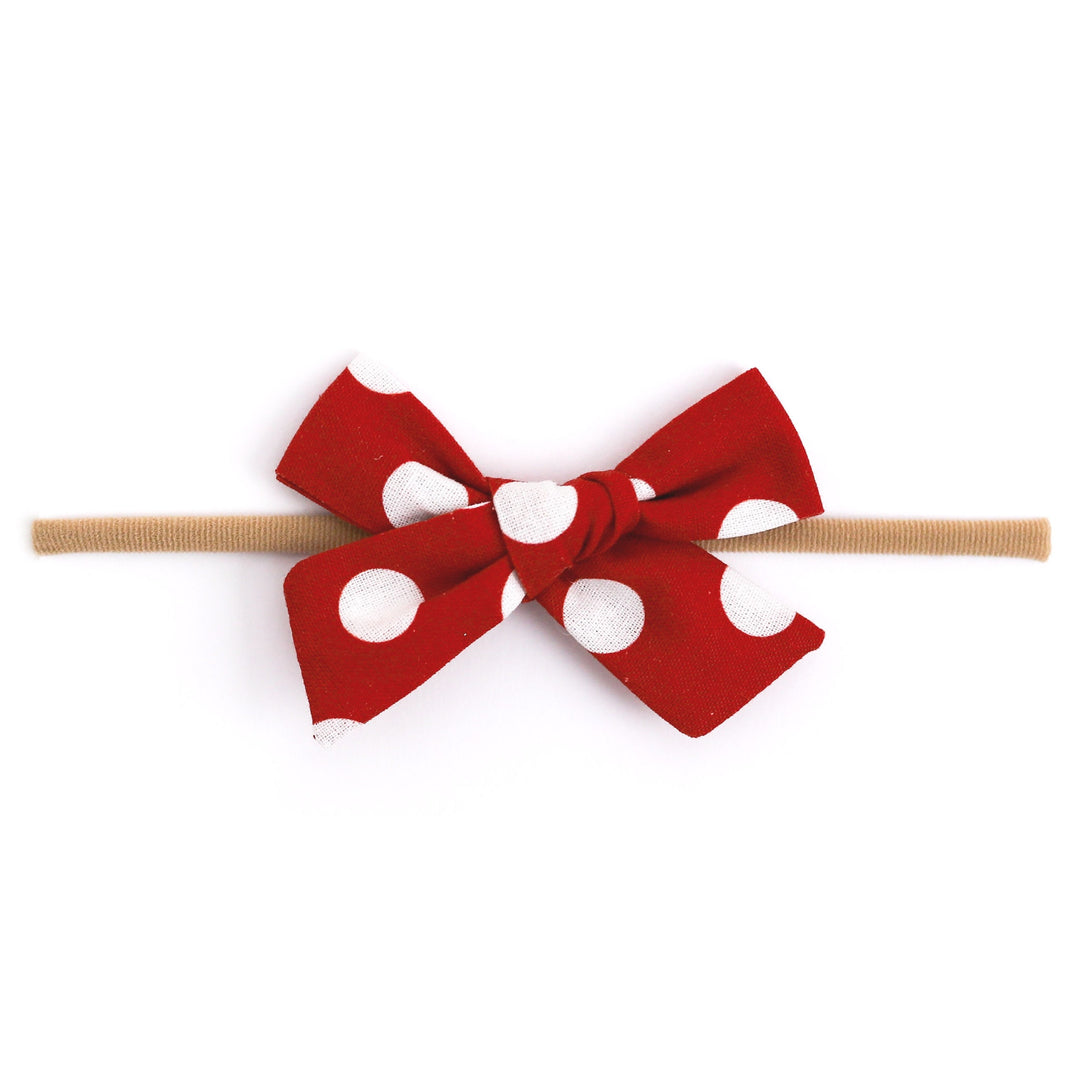 red and white dot baby bow on nylon headband