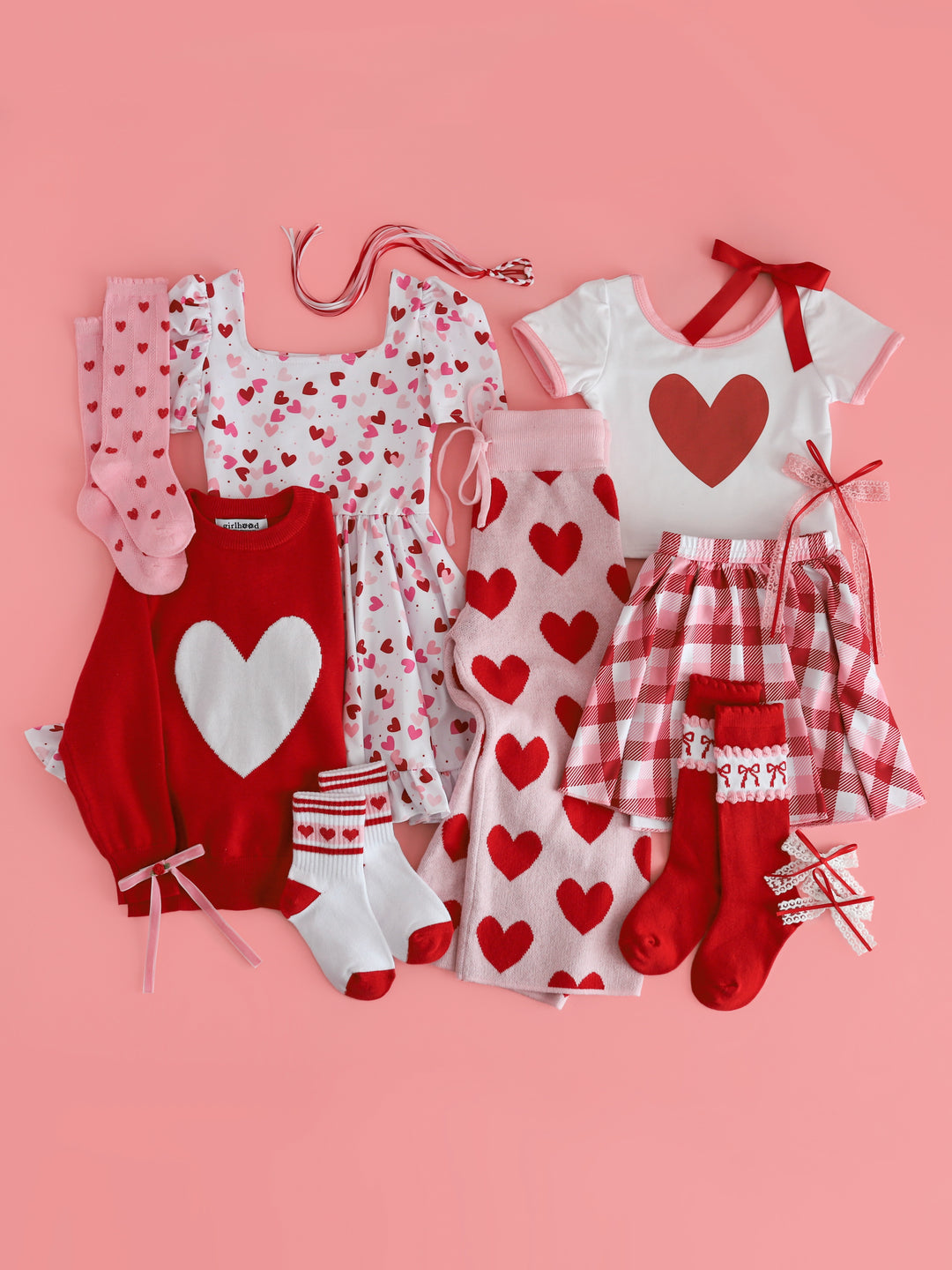 girls red and pink themed valentines flat lay with mix and match outfits and accessories featuring hearts