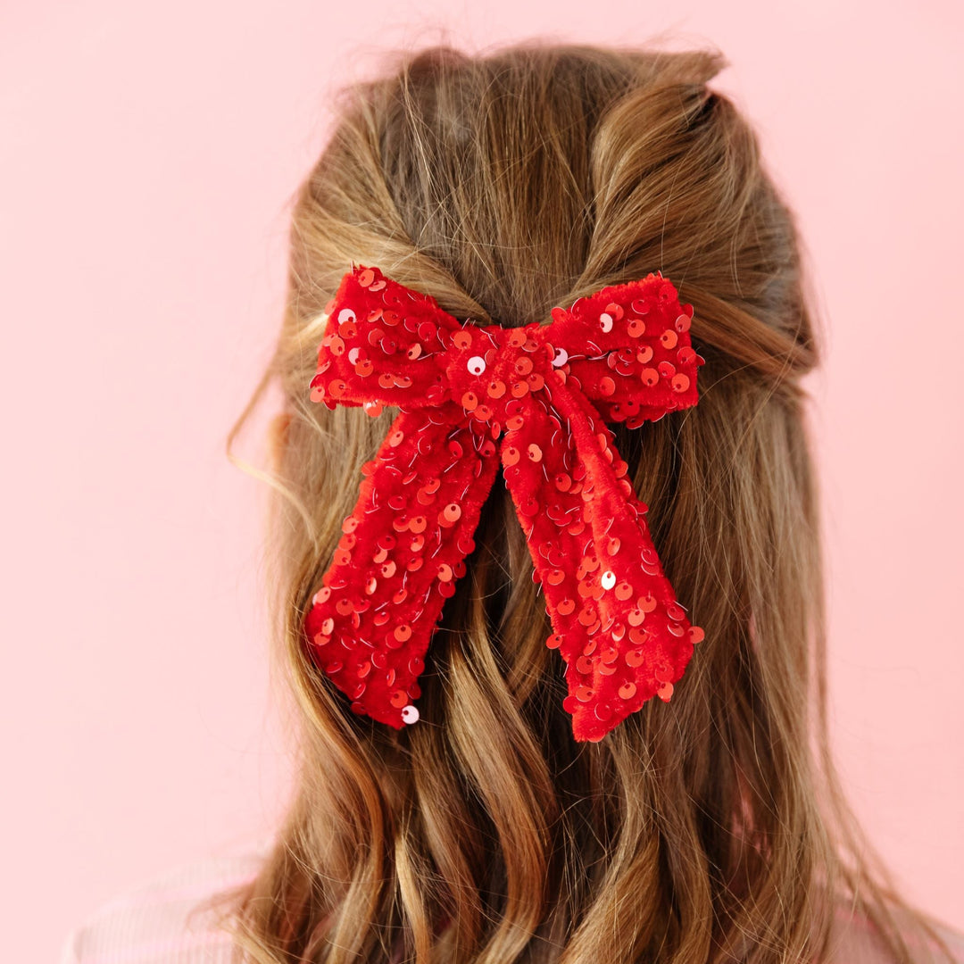 little girl in red velvet bow with red sequins for Valentine's Day