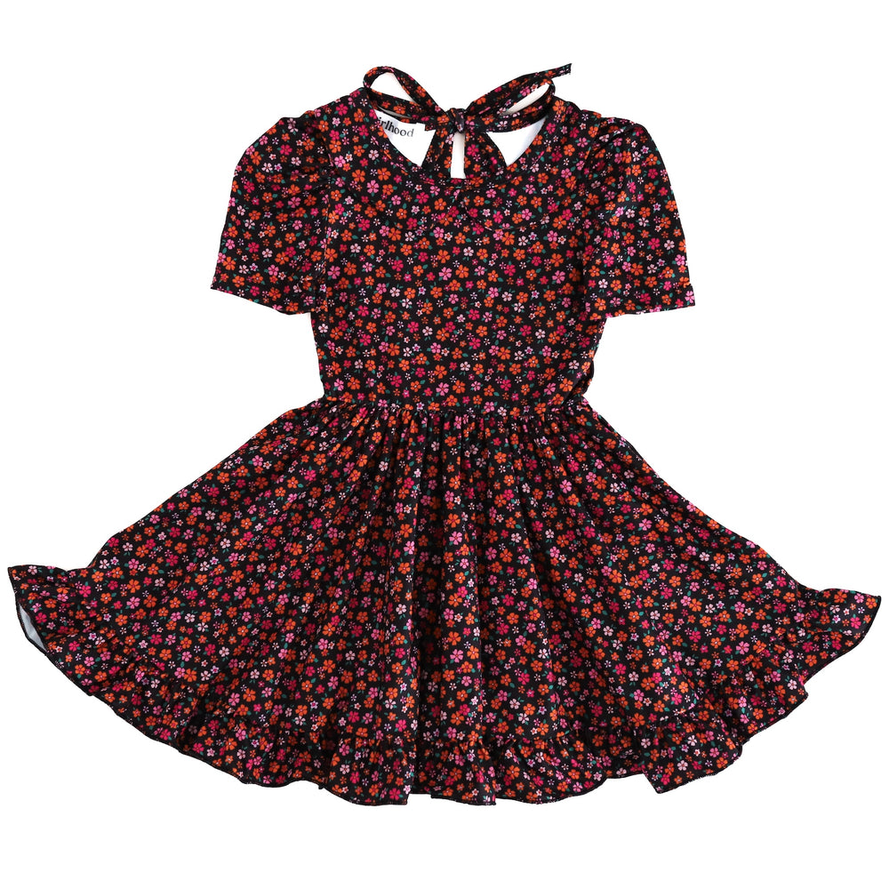 girls' petite pink and orange floral print on black twirl dress with peter pan collar, short sleeves and ruffled hem photographed on white background