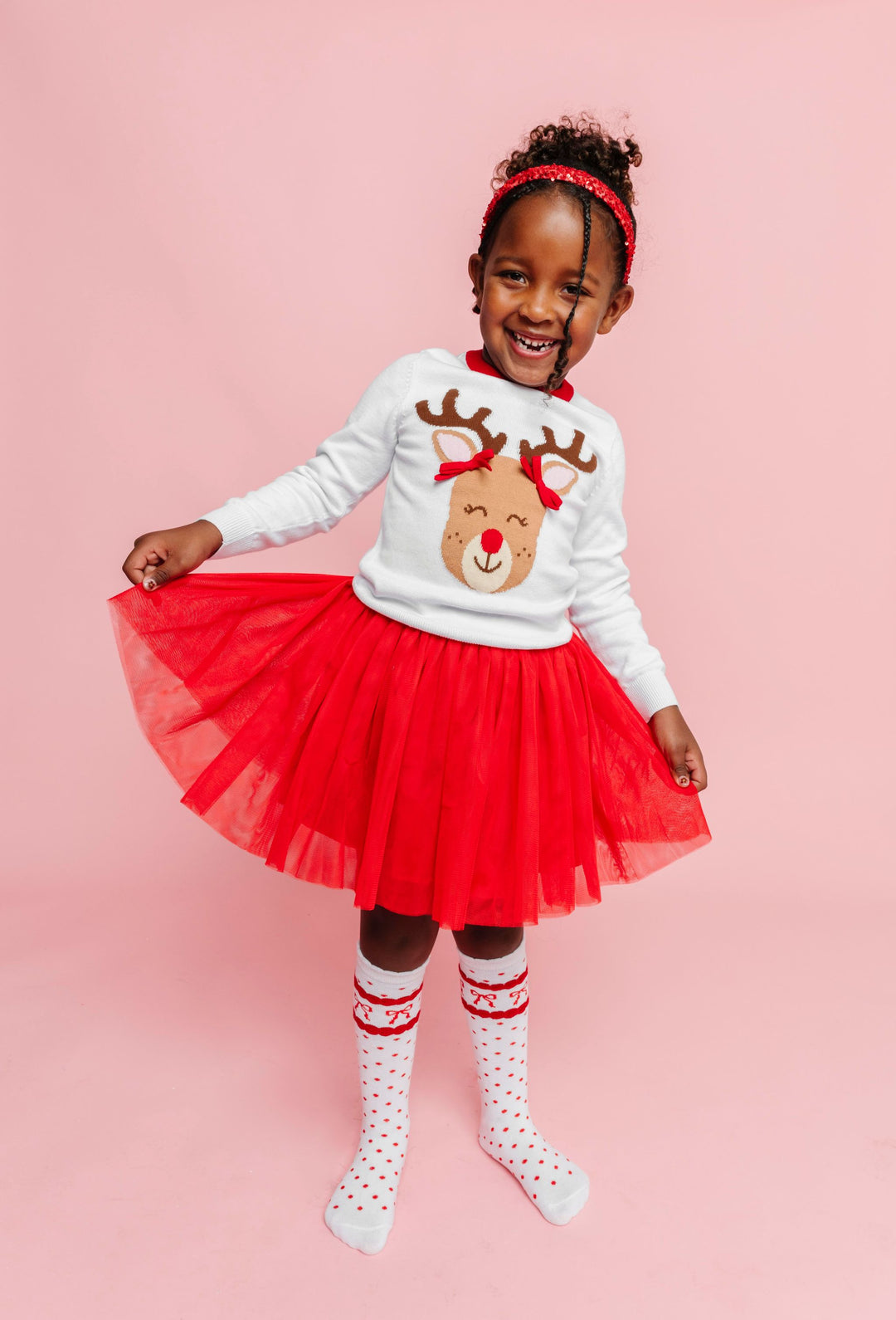 young girl in red and white Rudolph themed outfit with red tutu skirt and matching accessories for Christmas