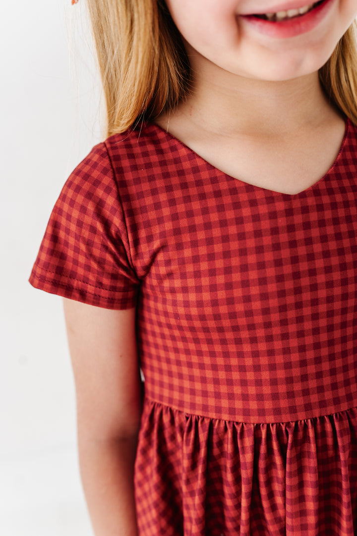 closeup of girl in rust and burgundy dress for fall